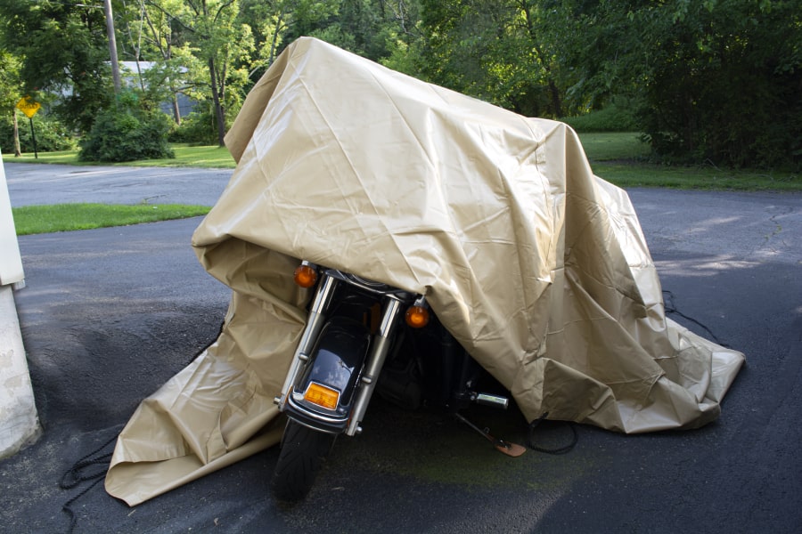 TAN TARP OVER MOTORCYCLE